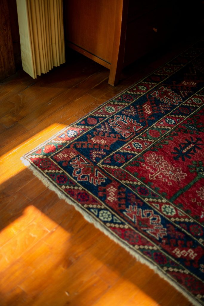 A wooden floor with a rug on top of it